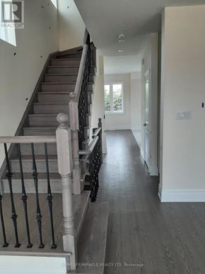 Brampton (Credit Valley) townhouse for rent - A hallway with a staircase and a door at the end.