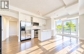 Toronto (Willowdale East) townhouse for rent - A spacious kitchen with white cabinets and a refrigerator.