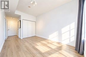 Toronto (Willowdale East) townhouse for rent - A room with white walls and wooden flooring, with a window on the right side.