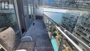 Toronto (Waterfront Communities) condo for rent - A balcony with a view of the water and buildings.