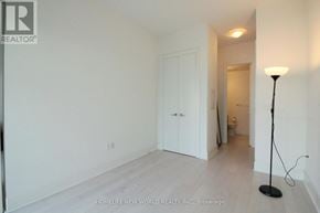 Toronto (Waterfront Communities) condo for rent - A room with a white door and a lamp on the floor.