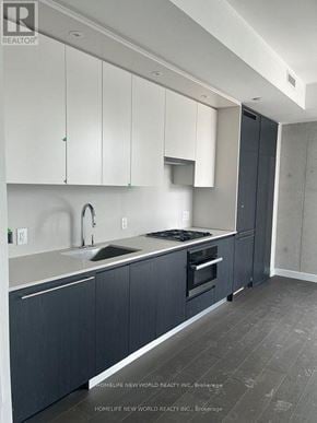 Toronto (Church-Yonge Corridor) condo for rent - A kitchen with white cabinets and a sink.