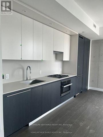 Toronto (Church-Yonge Corridor) condo for rent - A kitchen with white cabinets and a sink.