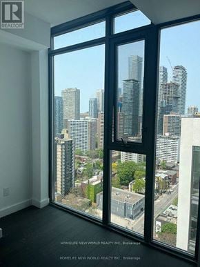 Toronto (Church-Yonge Corridor) condo for rent - A real estate company is advertising a property with a view of a city skyline.