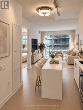 Toronto (Humber Heights) condo for rent - A well-lit, modern kitchen and living room with a large window.