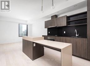 Toronto (Waterfront Communities) condo for rent - A modern kitchen with a large island in the middle.