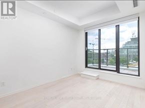 Toronto (Waterfront Communities) condo for rent - A room with a large window and wooden flooring.