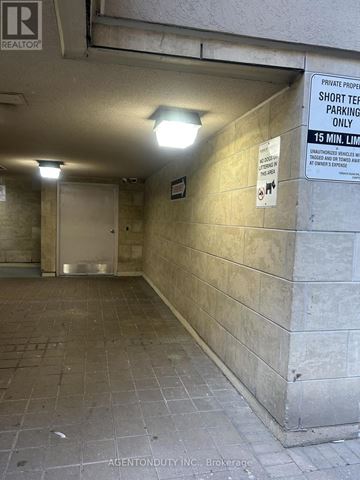 Toronto (Moss Park) condo for rent - A sign in a parking garage indicates that the space is for short-term parking only.