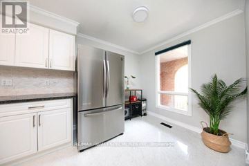Milton (Tm Timberlea) apartment for rent - A kitchen with white cabinets and a stainless steel refrigerator.