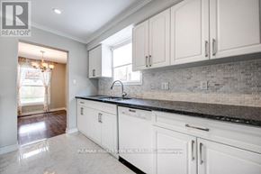 Milton (Tm Timberlea) apartment for rent - A kitchen with white cabinets and a marble countertop.