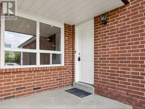 Mississauga (Hurontario) apartment for rent - A white door is on the right side of a brick wall.