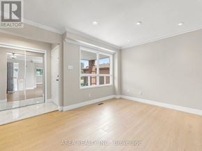 Mississauga (Hurontario) apartment for rent - A spacious room with wooden flooring and a large window.