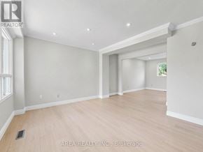 Mississauga (Hurontario) apartment for rent - A spacious room with wooden flooring and white walls.