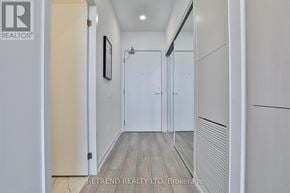 Toronto (Church-Yonge Corridor) condo for rent - A hallway with a wooden floor and white walls.