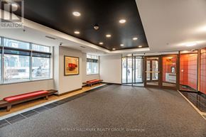 Ottawa condo for rent - A hallway with a bench and a painting on the wall.
