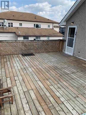 Welland (Welland Downtown) apartment for rent - A wooden deck with a chair on it.