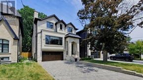 Toronto (Lansing-Westgate) apartment for rent - A large, modern house with a driveway in front.