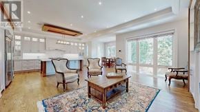Toronto (Lansing-Westgate) apartment for rent - A large, well-lit room with a wooden floor and a rug in the center.