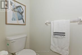 Milton (Cl Clarke) townhouse for rent - A white toilet with a white towel hanging on a towel rack.