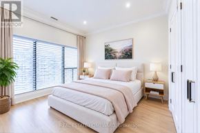 Toronto (Waterfront Communities) condo for rent - A bedroom with a large bed, a potted plant, and a painting on the wall.