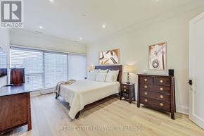 Toronto (Waterfront Communities) condo for rent - A bedroom with a bed, nightstand, and dresser.