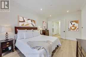 Toronto (Waterfront Communities) condo for rent - A bedroom with a large bed and a painting on the wall.