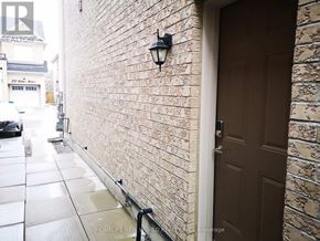 Markham (Cedarwood) apartment for rent - A brown door is on the right side of a brick wall.