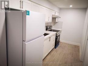 Markham (Cedarwood) apartment for rent - A kitchen with white appliances and cabinets.