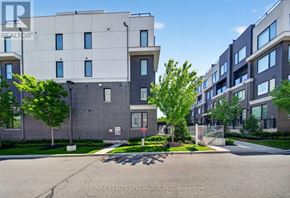 Mississauga (Erin Mills) townhouse for rent - A modern apartment complex with a clear blue sky above.