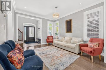 Oakville (Go Glenorchy) apartment for rent - A living room with a blue sofa and a red chair.