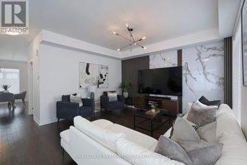 Oakville (Jm Joshua Meadows) townhouse for rent - A living room with a white couch and a black and white artwork on the wall.