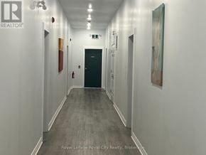 Centre Wellington (Elora/Salem) apartment for rent - A long hallway with doors on both sides and a painting on the wall.