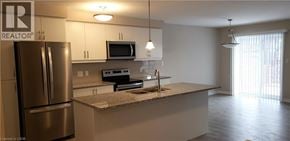 Kitchener townhouse for rent - A kitchen with a refrigerator, microwave, oven, and sink.