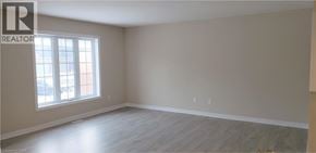 Kitchener townhouse for rent - A room with a window and wooden flooring.