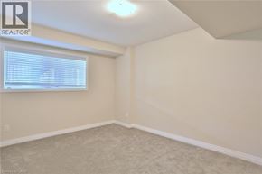 Kitchener townhouse for rent - A room with a window and a carpeted floor.