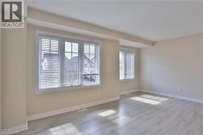 Kitchener townhouse for rent - A room with a window and wooden flooring.