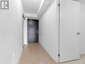 Toronto (Bay Street Corridor) condo for rent - A white door is closed in a room with a white wall.
