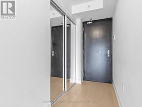 Toronto (Bay Street Corridor) condo for rent - A hallway with a black door and a white door with a glass panel.