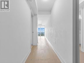 Toronto (Bay Street Corridor) condo for rent - A long hallway with a door at the end.