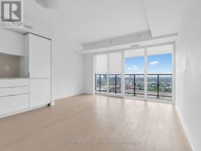 Toronto (Bay Street Corridor) condo for rent - A spacious room with a view of the cityscape through the windows.