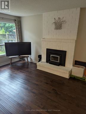 Caledon (Bolton West) apartment for rent - A living room with a fireplace and a television.