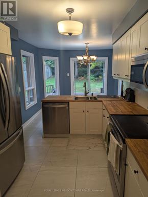 Caledon (Bolton West) apartment for rent - A kitchen with a refrigerator, cabinets, and a dishwasher.