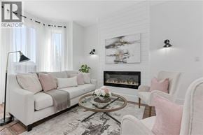 Hamilton townhouse for rent - A living room with a fireplace, a sofa, a chair, and a coffee table.