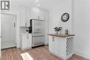 Hamilton townhouse for rent - A kitchen with white cabinets and a stainless steel refrigerator.