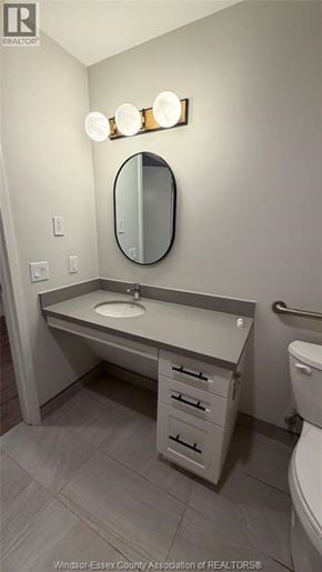 Windsor apartment for rent - A bathroom with a sink, mirror, and toilet.