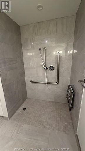 Windsor apartment for rent - A shower area with a glass door and a glass shower head.
