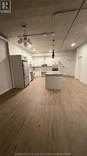 Windsor apartment for rent - A kitchen area with a refrigerator, cabinets, and a counter.