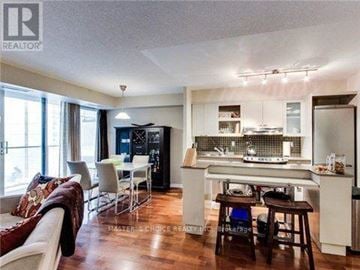 Toronto (Bay Street Corridor) condo for rent - A well-lit kitchen with a dining table and chairs.