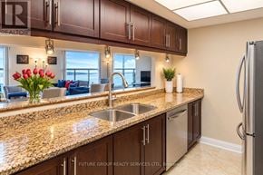 Toronto (Waterfront Communities) condo for rent - A kitchen with granite countertops and stainless steel appliances.