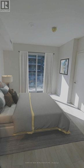 Toronto (Flemingdon Park) condo for rent - A bedroom with a large bed and a window with curtains.